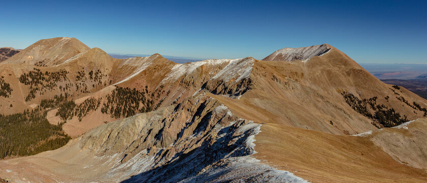 This scenic La Sal Mountain panorama near Moab, Utah, features Mount Peale and Mount Mellenthin on an autumn blue bird day.