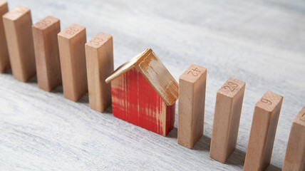 Wooden model of house with a wooden blocks.