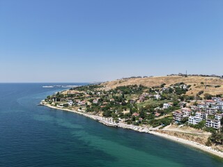 Fototapeta premium Aerial Panoramic View of Coastal Residential Neighborhood and Blue Sea Horizon