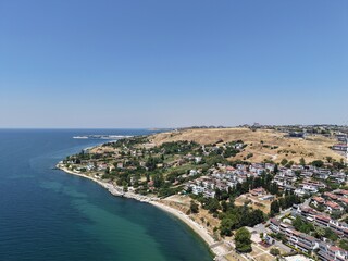 Fototapeta premium Aerial Panoramic View of Coastal Residential Neighborhood and Blue Sea Horizon