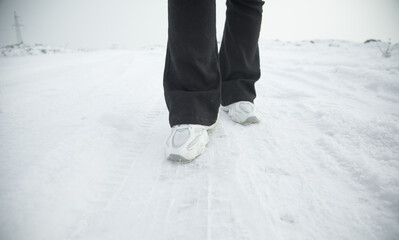 Woman walking in snow at winter.