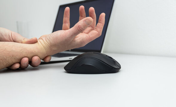 Male hand not working with cramp, nerve pain when he working with mouse. Illness while using laptop, office work