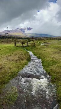 Curvy Stream Cutting Through Meadow with Volcano (Cotopaxi National Park, Ecuador)