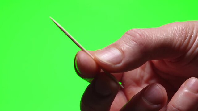 toothpick close-up on a green isolated background