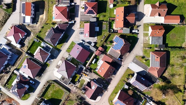 Aerial View of Residential Neighborhood with Solar Panels on Rooftops