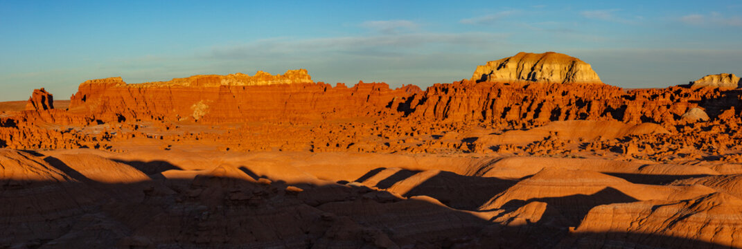 This scenic panorama of Goblin Valley State Park, Utah, features soft light illuminating the colorful eroded features of the park.