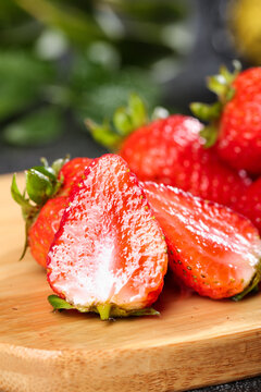 Fresh Dandong Strawberries Cut in Half on Wooden Board - Healthy Vitamin Rich Fruit