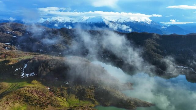 Aerial drone cinematic video of amazing artificial lake Aoou with beautiful nature and reflecting clouds near picturesque village of Metsovo surrounded by mountains of Pindus, Epirus, Greece