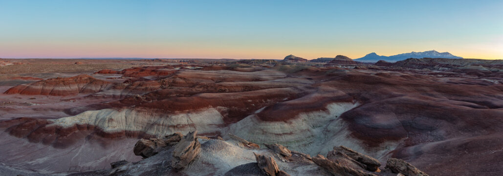 This scenic sunset panorama of the Blue Hills in the San Rafael Swell near Hanksville, Utah, features their red and purple hues.