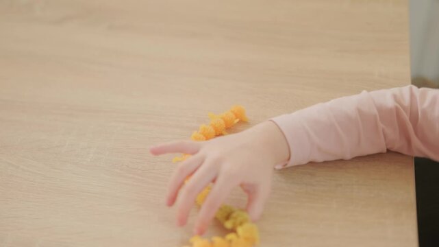 Preschool girl plays with flexible caterpillar toy, silicone, bright colors, sensory fun, fine motor skills, early education, sensory toy