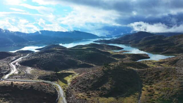 Aerial drone cinematic video of amazing artificial lake Aoou with beautiful nature and reflecting clouds near picturesque village of Metsovo surrounded by mountains of Pindus, Epirus, Greece