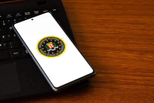 Punta Arenas, Chile &ndash; March 05, 2026: A smartphone screen displaying the official seal of the Federal Bureau of Investigation (FBI), resting on a black laptop keyboard