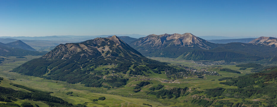 This scenic summer mountain panorama features Mt Crested Butte and Whetstone Mountain rising above the towns of Mount Crested Butte and Crested Butte, Colorado.