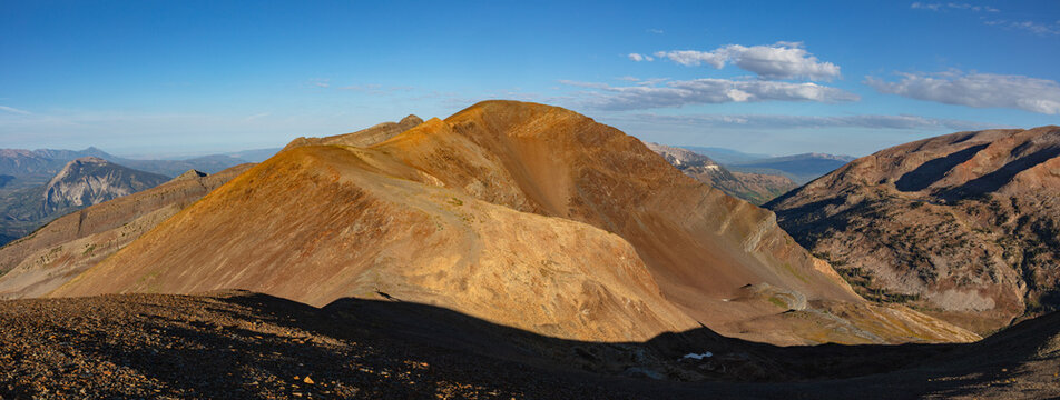 This colorful mountain panorama features Colorado 12er Unnamed 12,786', located near Yule Pass outside of Crested Butte, CO, under a vibrant blue sky.