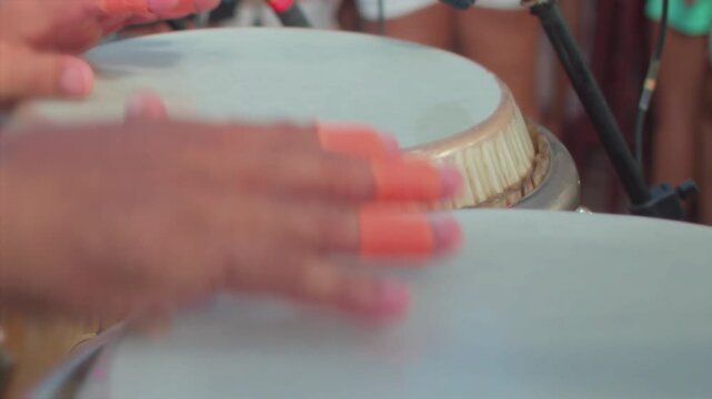 Close-up of a musician playing a percussion instrument.