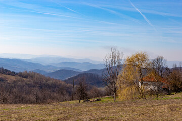 Obraz premium Rural landscape in the Balkan Mountains with village houses in early spring.