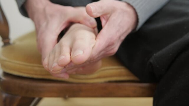 male hands check aching foot, focusing on bunion deformity, flatfoot issues, and age-related foot chronic pain, Aging foot care, addressing bunion pain, flatfoot discomfort, health issues