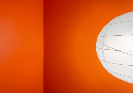 Minimal orange wall with white paper lantern