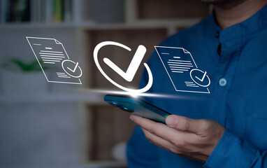 checkmark for digital approval and task completion. online procurement documents, contract warranties and licenses on mobile procurement devices for businesses and startups © Krittamet