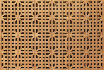 Naklejka premium Panjara background texture. Decorative wooden lattice screen with repeating geometric pattern and warm timber tones, ideal for Oriental architecture, interior design, backgrounds and textures