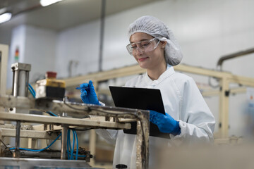 Packaging of canned fish. Packing canned fish in the warehouse. Worker working, writing clipboard...