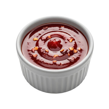 White ramekin filled with thick dark red barbecue sauce with visible chili flakes isolated on a transparent background