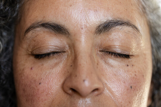 African American senior woman showing closed eyelids and skin texture in extreme close-up portrait