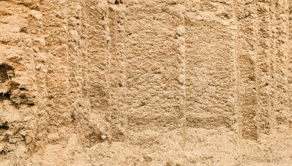 Close-up of textured silo pit straw bales in stacked hay bale wall at farm