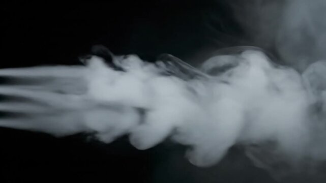 Super slow motion smoke effect of visible exhalation in cold conditions, filmed at 500 fps on a high-speed camera. Isolated on black background