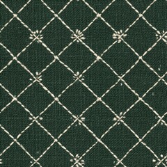 Fototapeta premium Embroidered dark green textile with white diamond grid and floral accents