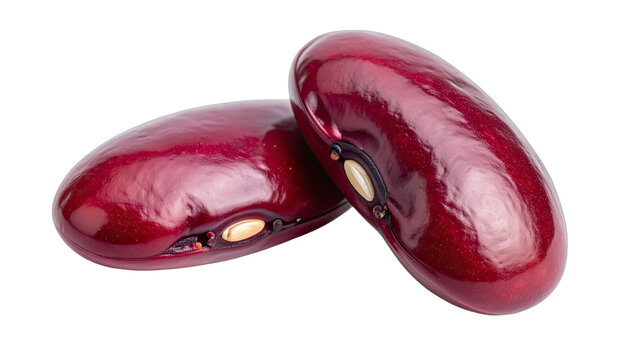 Two glossy, deep red kidney beans isolated on a black background.