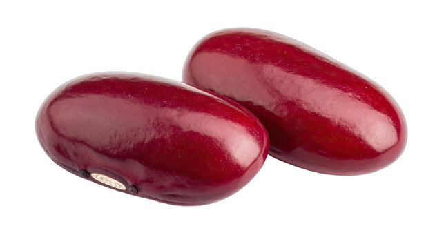 Two glossy, deep red kidney beans isolated against a solid black background in a close-up studio shot.