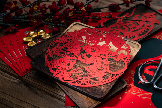 Traditional Chinese Paper Cutting Art with Scissors and Decorative Elements