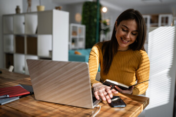 Woman working remotely at home office with laptop
