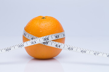 Fresh Orange with Measuring Tape - Diet and Health Concept