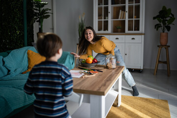 Mother and son playing together in living room