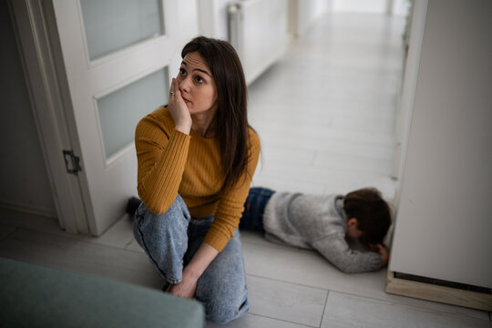 Stressed mother experiencing parenting burnout with child having tantrum