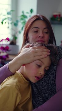 Mother comforting young son with gentle embrace at home, tender parenting moment, emotional support and intimate family connection