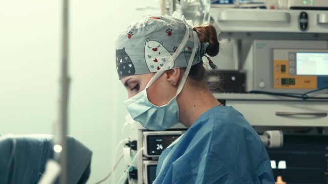Close-up of surgeon concentrating during operation in sterile environment. Surgery concept.
