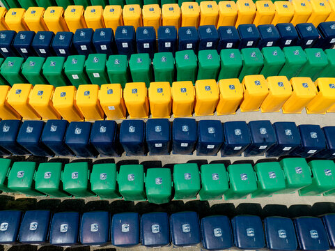 Aerial view of rows of multicolored stadium seats creating a vibrant mosaic of yellow, green, and blue echoing the city's lively spirit, Lisbon, Lisbon, Portugal.