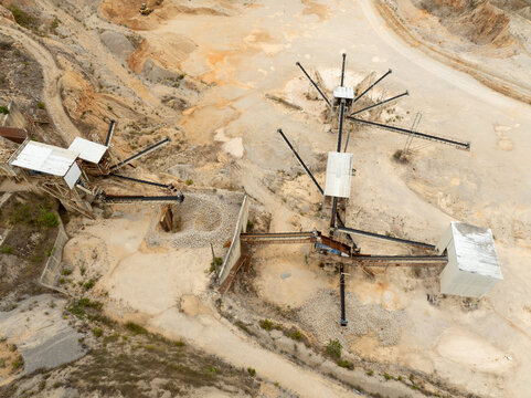 Aerial view of industrial structures stand stark against the pale earth, a network of pipes and platforms creating a geometric landscape, Redinha, Leiria, Portugal.
