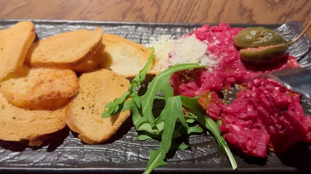 Fresh tartare and crispy toast bread served on a plate
