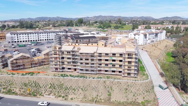 Construction of residential buildings with scaffolding and earthquake resistant techniques takes place in a developing urban area.