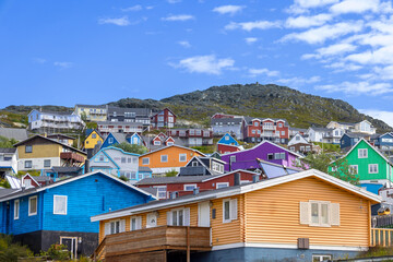 Typical architecture of Greenland city Qarqotoq with colored houses located near fjords and icebergs © eskystudio