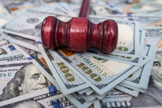 Close up of Gavel on Hundred Dollar Bills for Financial Crime Investigation and Corruption Concept