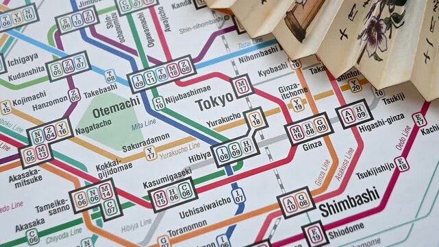 Tokyo subway map showing urban transport routes with a decorative japanese fan