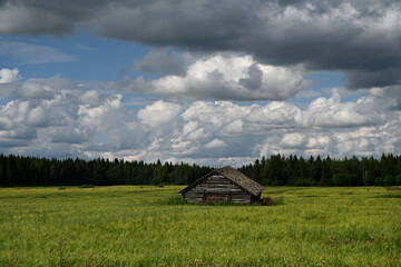 Fototapeta premium Landscape with a cabin in Lapland, Finland. Typical Finnish landscape with a wood cabin in forest
