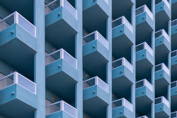 Modern blue apartment buildings in Torrevieja, Spain with repetitive balconies and geometric...