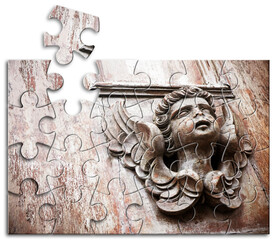 Obraz premium SCULPTURE OF AN ANGEL ON A WOODEN DOOR - The slow faith building or loss - Faith building or loss concept in jigsaw puzzle shape