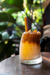 Naklejka premium Artisan Layered Coffee Drink in Tropical Cafe in Hoi An